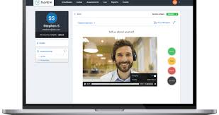 Laptop screen showing an online video interview platform with a smiling man wearing headphones, used for virtual job interview practice.