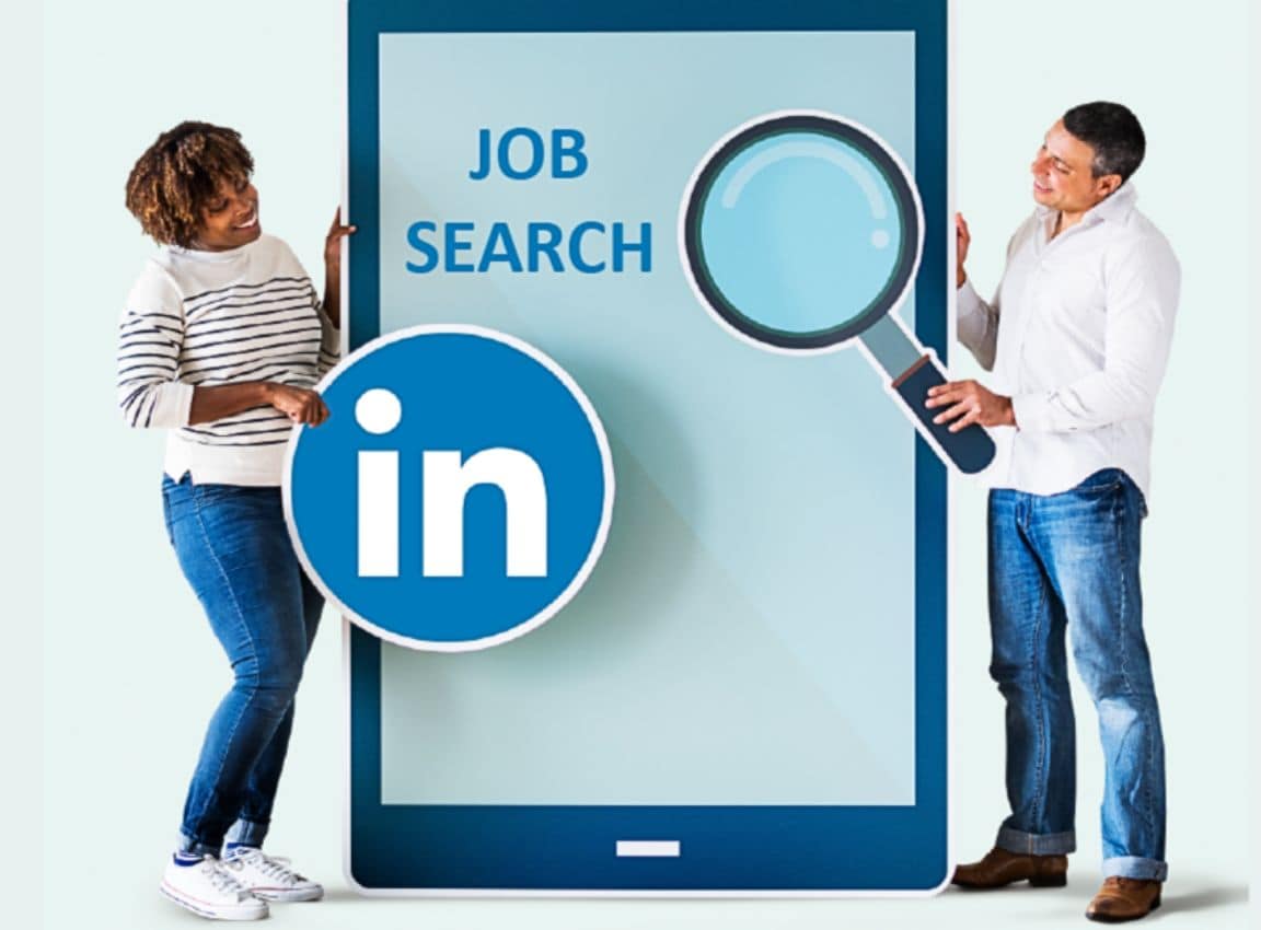 Man and woman standing next to a large phone screen with LinkedIn logo and magnifying glass, showing LinkedIn job sear